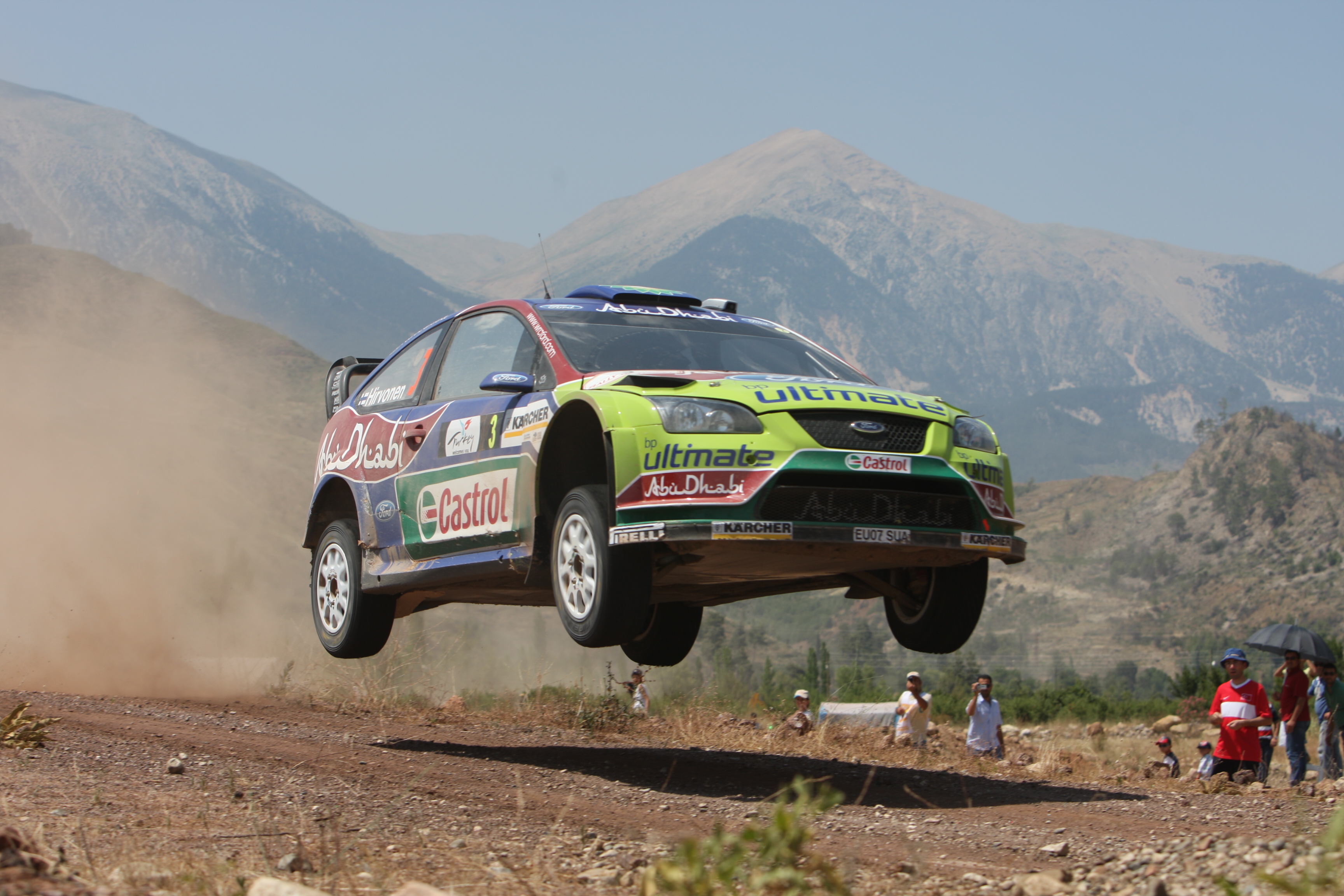 mountains, cars, jumping, dust, rally, airborne, racing, Ford racing, races, rally cars, offroad, gravel, Ford Focus WRC, racing cars, jump - desktop wallpaper